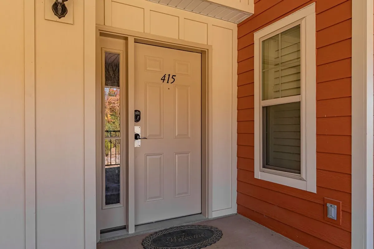 A welcoming entrance with a front door, colorful siding, and a cheerful welcome mat. The inviting entryway hints at the comfort and warmth awaiting inside, setting the tone for a memorable stay.